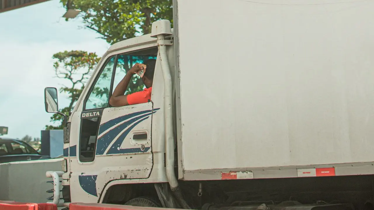 white van near white and blue signage